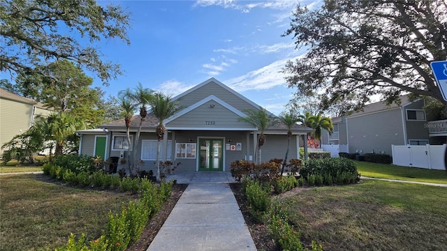 view of front of home featuring a front yard and french doors