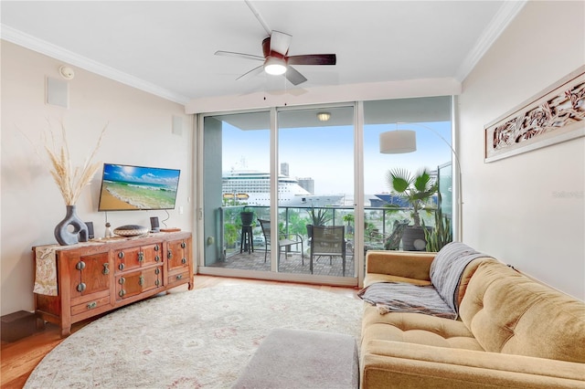 living room with ceiling fan, ornamental molding, floor to ceiling windows, and hardwood / wood-style floors