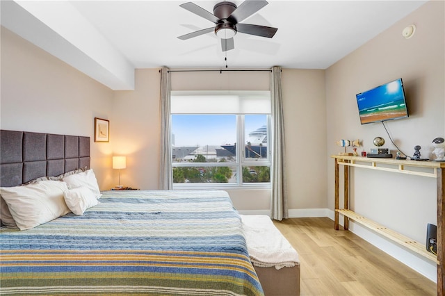 bedroom with ceiling fan and light hardwood / wood-style floors