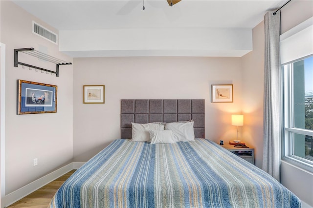 bedroom with light wood-type flooring and ceiling fan