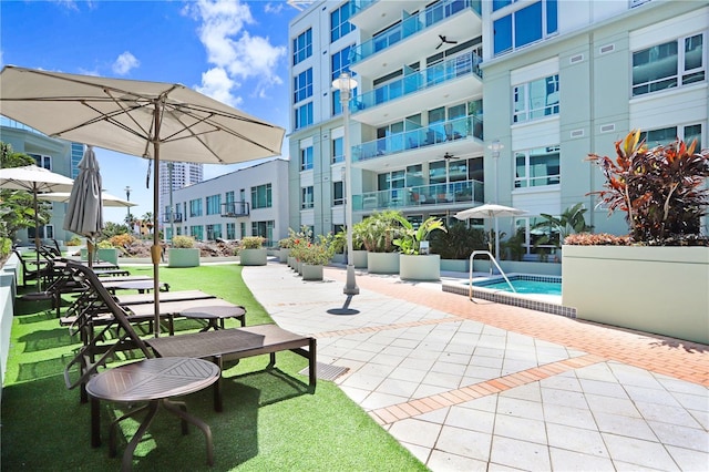 view of community featuring a patio area and a pool