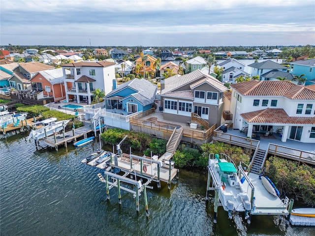 bird's eye view featuring a water view and a residential view