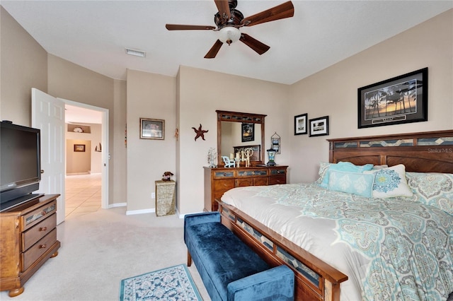 bedroom with ceiling fan and light carpet