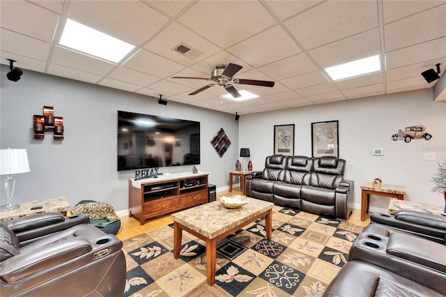 living room featuring ceiling fan and a paneled ceiling