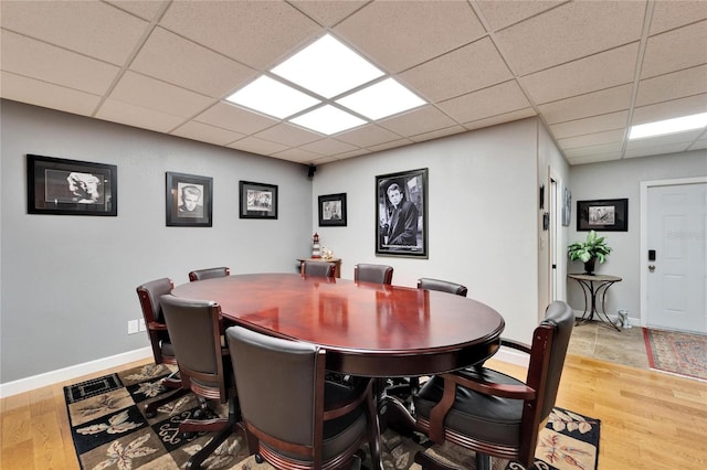 dining room with hardwood / wood-style floors and a drop ceiling