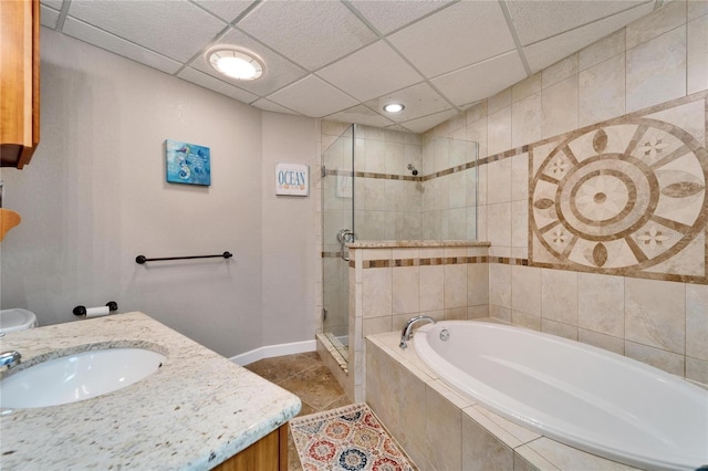 bathroom with vanity, shower with separate bathtub, a paneled ceiling, and tile patterned flooring