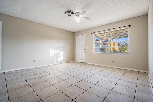 unfurnished room with ceiling fan, a textured ceiling, and light tile patterned flooring