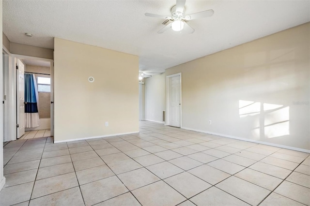 tiled empty room with ceiling fan