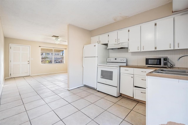 kitchen featuring light tile patterned floors, white appliances, white cabinets, and sink