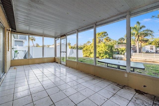 unfurnished sunroom with wooden ceiling