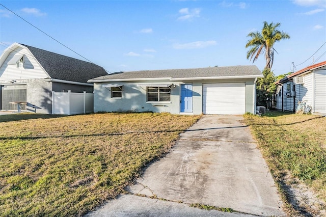 ranch-style house with a garage, a front yard, and central AC