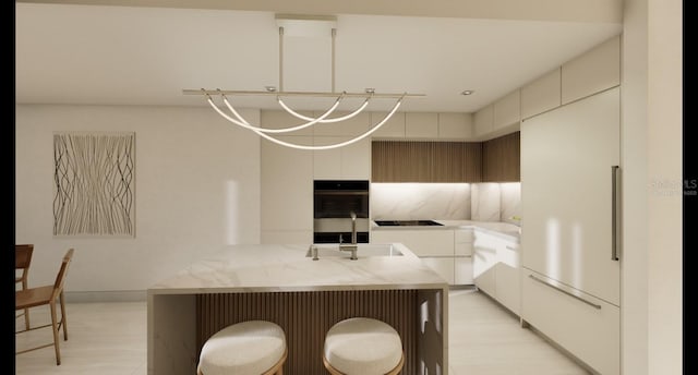 kitchen featuring sink, black electric stovetop, double wall oven, and a kitchen island