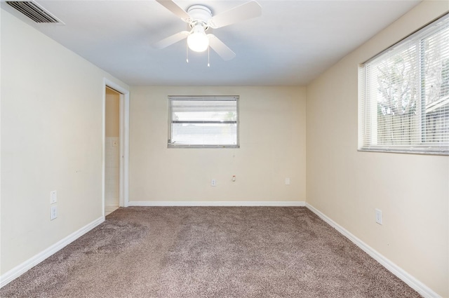 carpeted empty room featuring ceiling fan