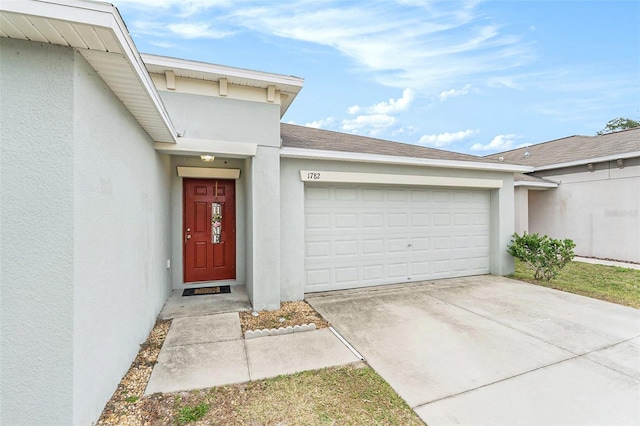 view of exterior entry with a garage