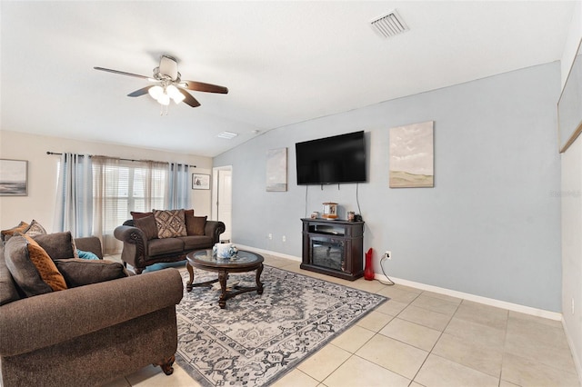 tiled living room with ceiling fan and vaulted ceiling