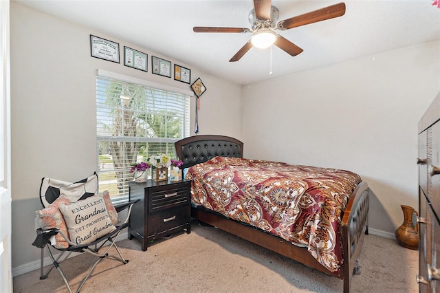 carpeted bedroom featuring ceiling fan and multiple windows