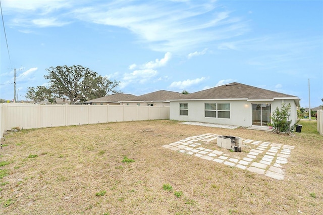 back of house featuring an outdoor fire pit, a patio area, and a yard