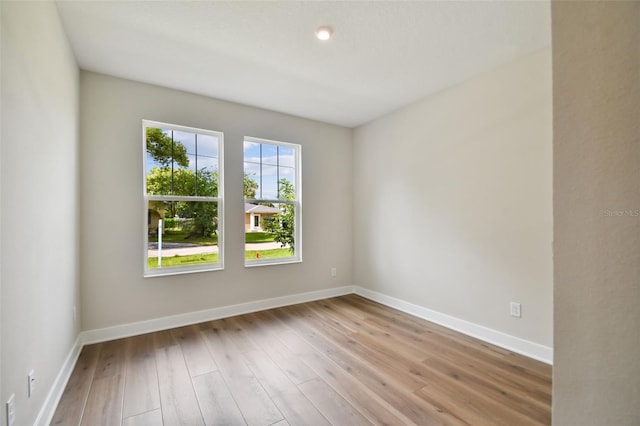 unfurnished room with light wood-type flooring