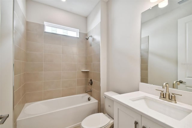 full bathroom with toilet, vanity, and tiled shower / bath