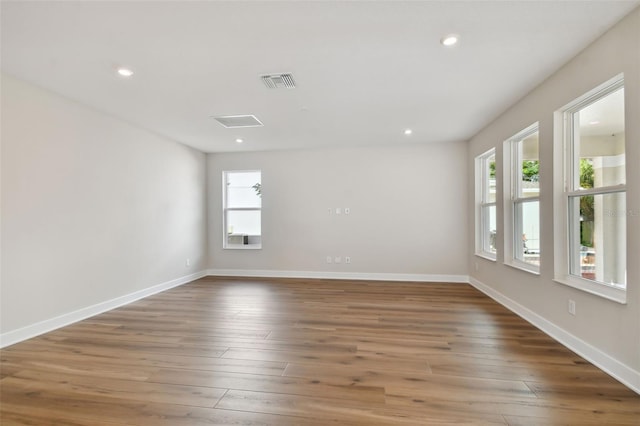 unfurnished room with dark hardwood / wood-style flooring