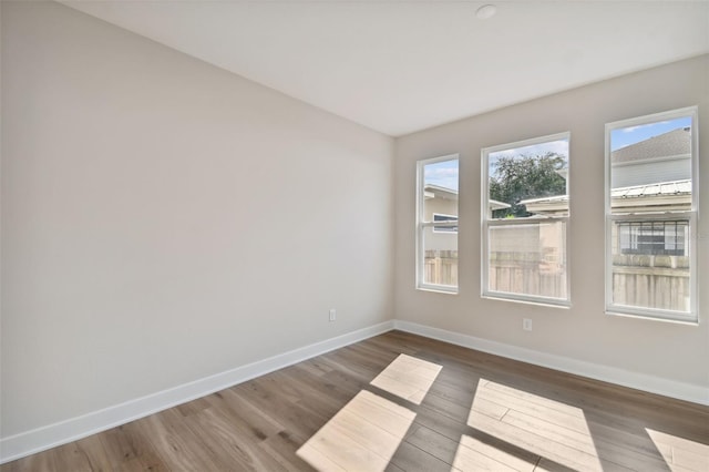 empty room with hardwood / wood-style flooring