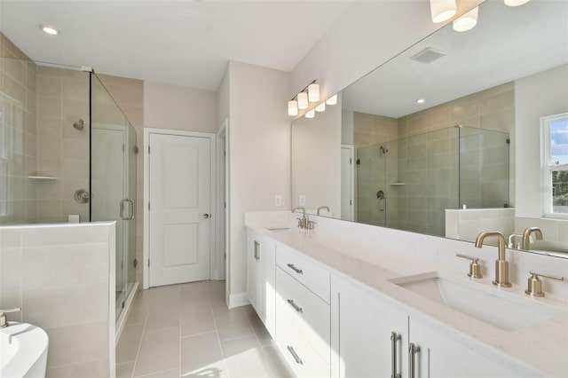 bathroom with an enclosed shower, vanity, and tile patterned flooring