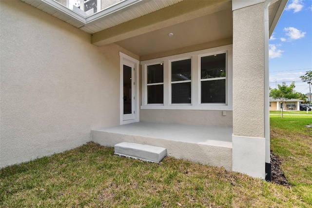 entrance to property featuring a yard