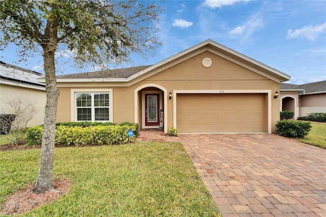 ranch-style home with a garage and a front lawn