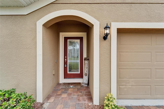 view of exterior entry featuring a garage