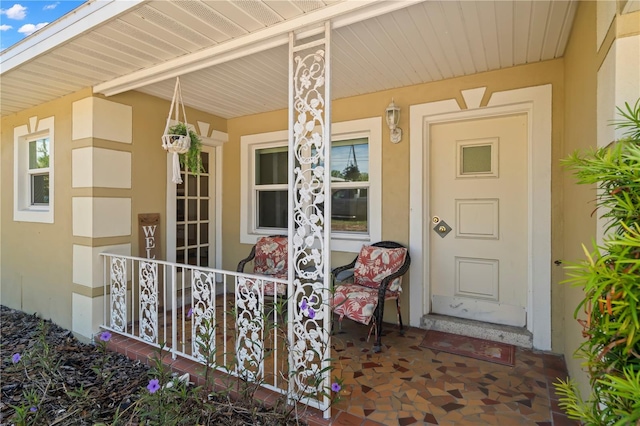 view of exterior entry with a porch