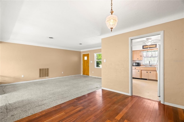 spare room featuring sink and dark hardwood / wood-style flooring