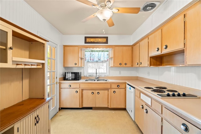 kitchen featuring white dishwasher, sink, and light brown cabinetry