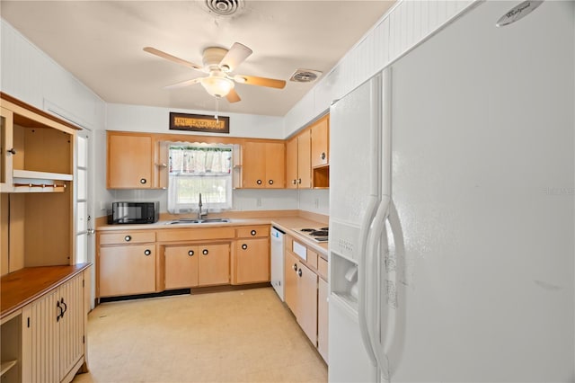 kitchen featuring ceiling fan, sink, light brown cabinetry, and white appliances