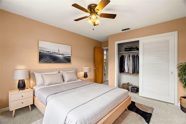 carpeted bedroom with ceiling fan and a closet