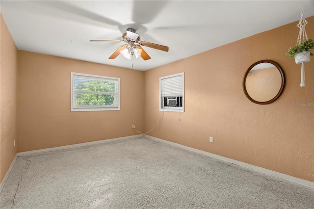 empty room featuring ceiling fan and cooling unit