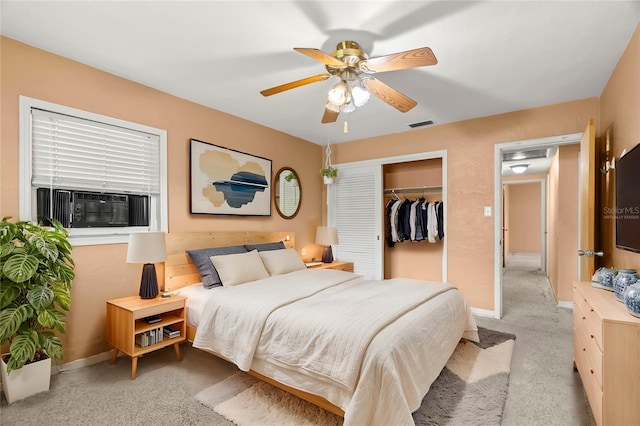 bedroom with ceiling fan, light colored carpet, a closet, and cooling unit