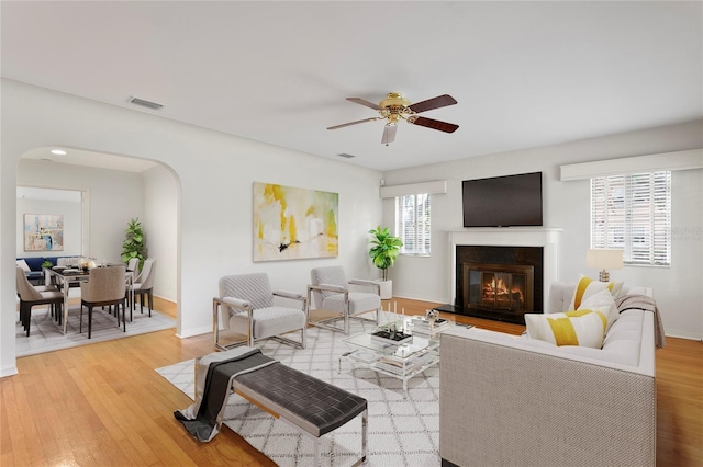 living room with ceiling fan and light hardwood / wood-style flooring