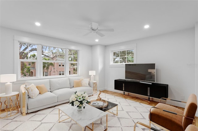 living room featuring ceiling fan and a wealth of natural light