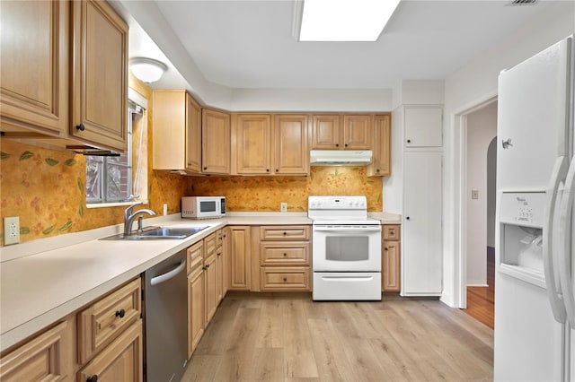 kitchen with light wood-type flooring, sink, backsplash, and white appliances