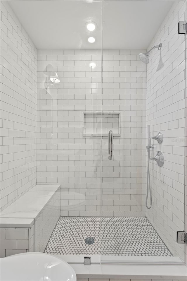 bathroom featuring a shower with door