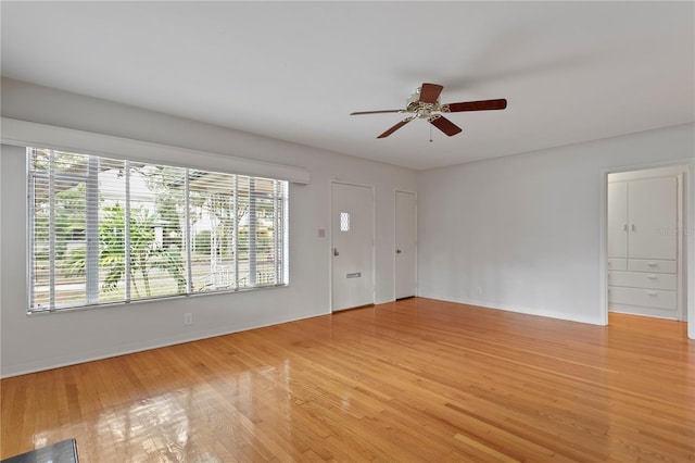 empty room with ceiling fan and wood-type flooring