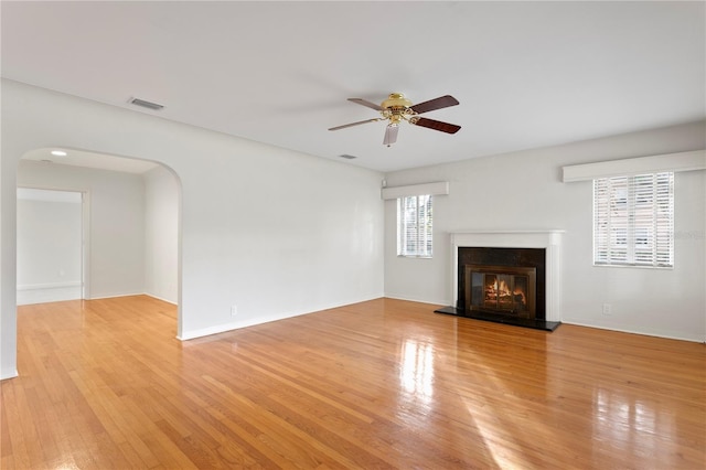 unfurnished living room featuring ceiling fan and light hardwood / wood-style flooring