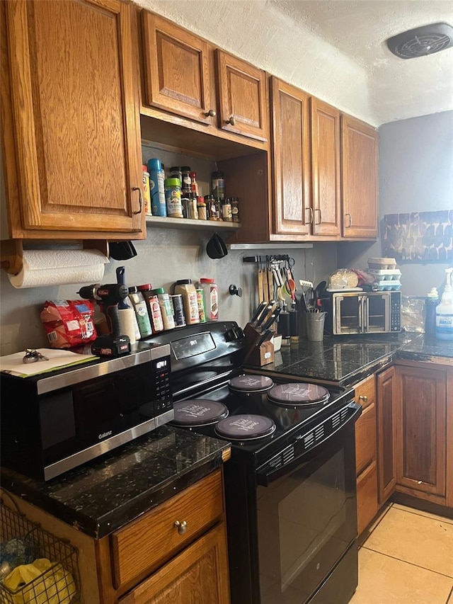 kitchen featuring light tile patterned floors and black electric range