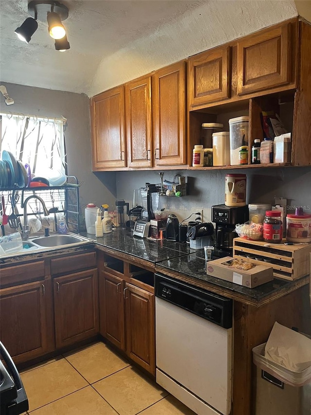 kitchen with ceiling fan, light tile patterned floors, white dishwasher, and sink