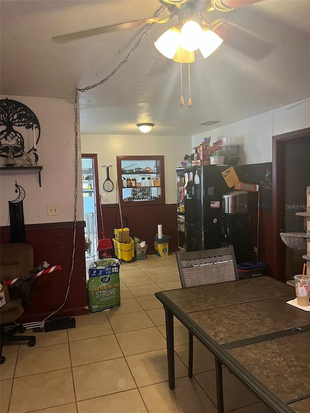 tiled dining room featuring ceiling fan