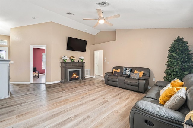 living room with light hardwood / wood-style floors, lofted ceiling, and ceiling fan