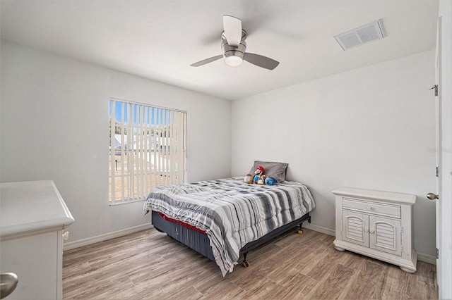 bedroom with hardwood / wood-style floors and ceiling fan