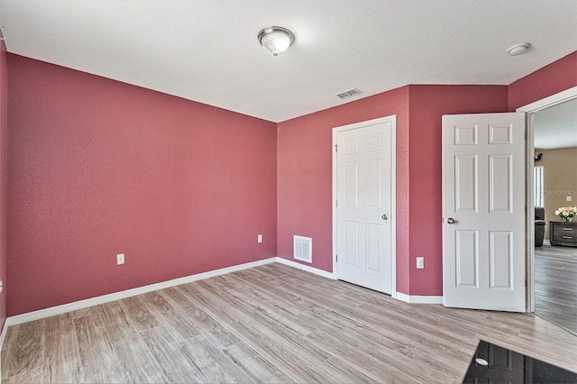 unfurnished bedroom with light hardwood / wood-style floors