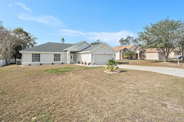 single story home featuring a garage and a front lawn