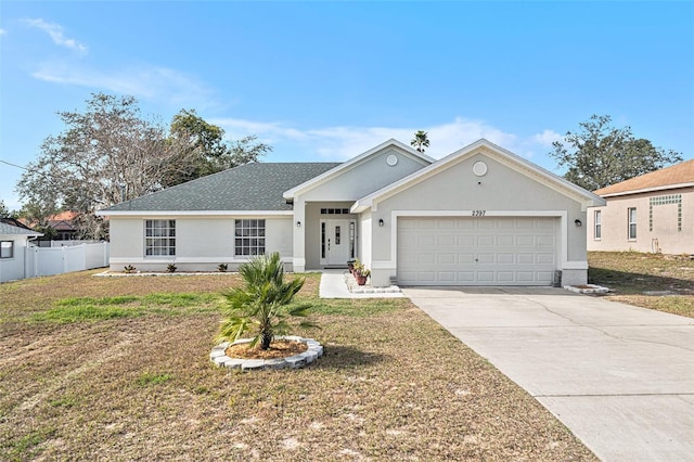 ranch-style home featuring a garage and a front yard